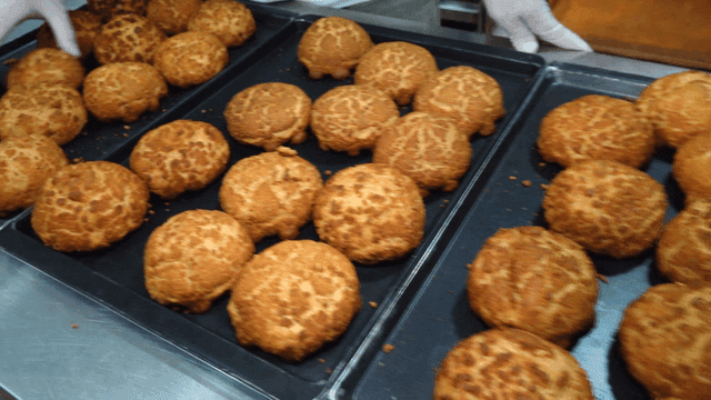 Freshly baked choux pastries on trays