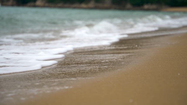 Gentle Waves Washing Over Sandy Beach