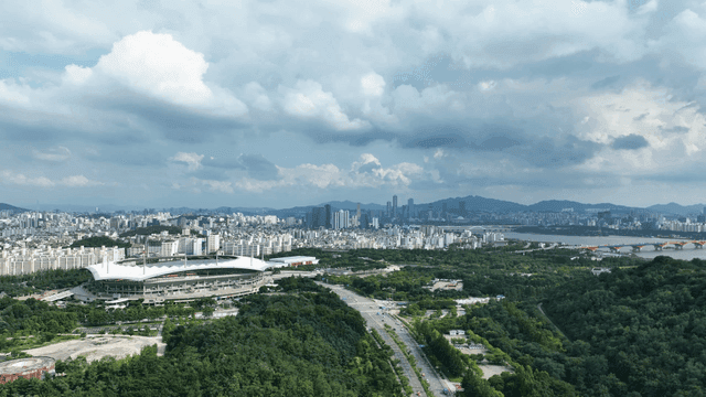 Vast city landscape with stadiums and greenery
