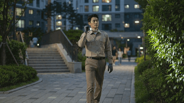 Security guard patrolling apartment at night