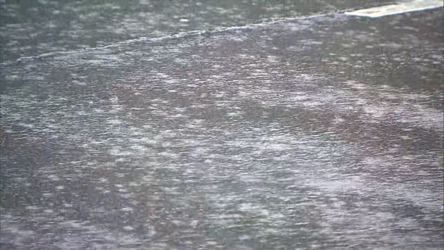 Close-up of Rain Droplets on Street Surface