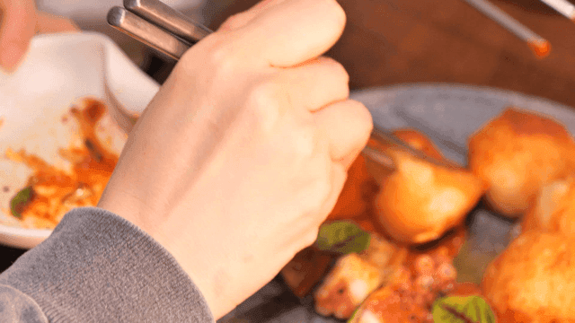 Sight of picking up potato dipped in sauce with chopsticks