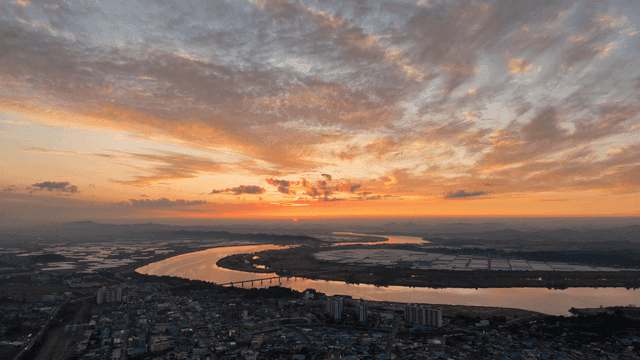 Serene sunset over winding river.