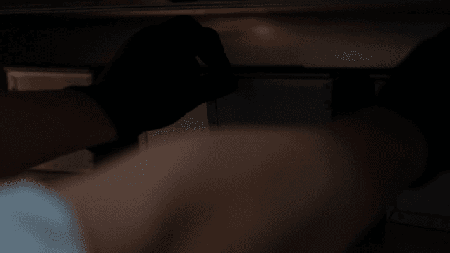 Baker putting baking tray in oven