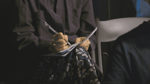 Person reviewing documents with their knees