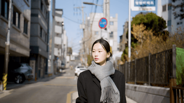 Young woman walking on sunny street