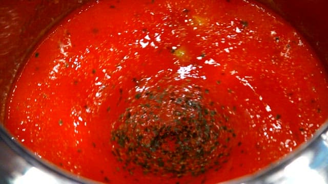 Spicy sauce being blended in a pot