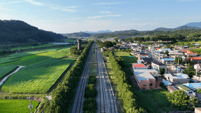 Rural village with fields and railroad
