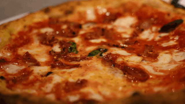 Freshly baked oven-baked pizza topped with basil