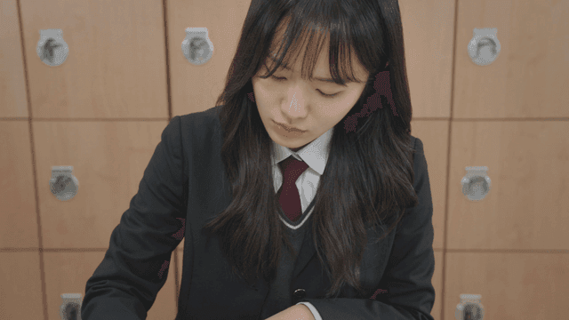 Student studying at a desk in a classroom