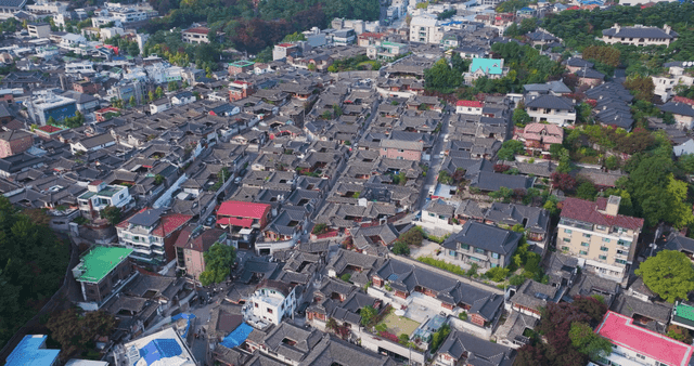 Panoramic view of a Hanok village lined with traditional tiled roofs