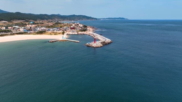 Coastal town with a lighthouse and pier