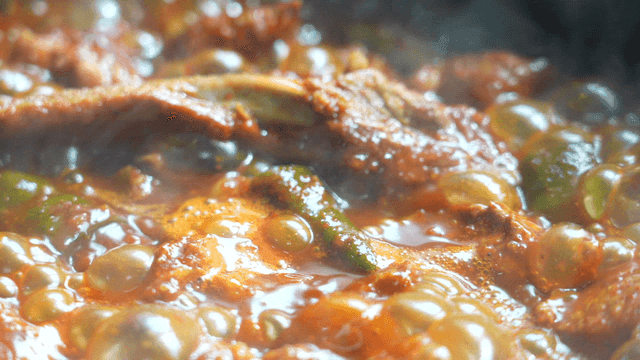 Bubbling spicy broth rising from braised ribs