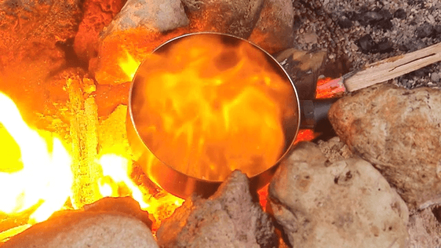 Cooking over an open fire with rocks