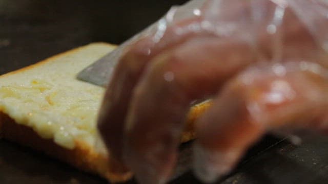 Spreading butter on bread with a knife