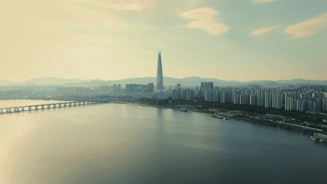 A city skyline with a river and bridge