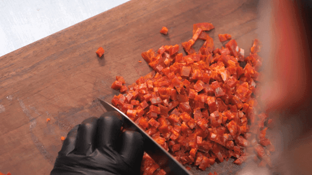 Sight of slicing chorizo ​​on wooden cutting board