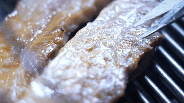 Grilling pork belly on a hot grill
