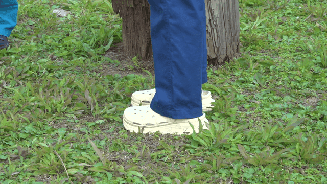 Person stretching their calves on grass