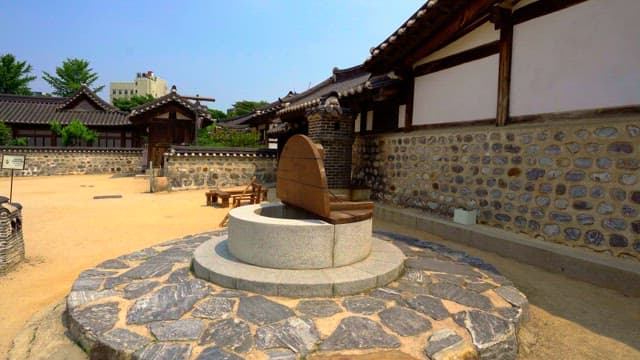 Traditional Korean house courtyard with well in the midday sun