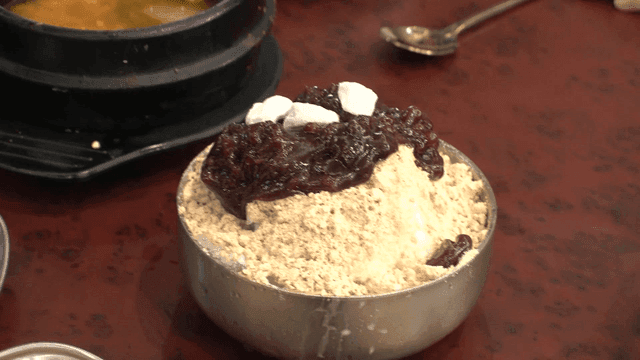 Korean shaved ice dessert topped with red beans and rice cakes