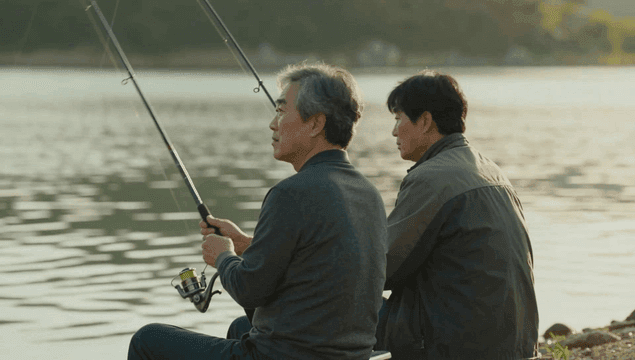 Father and son fishing on tranquil lake