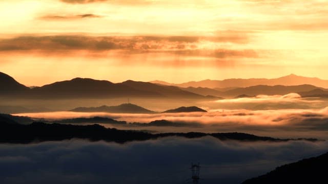 Sunrise over misty mountains