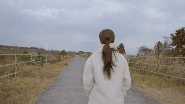 A woman walking on a rural path