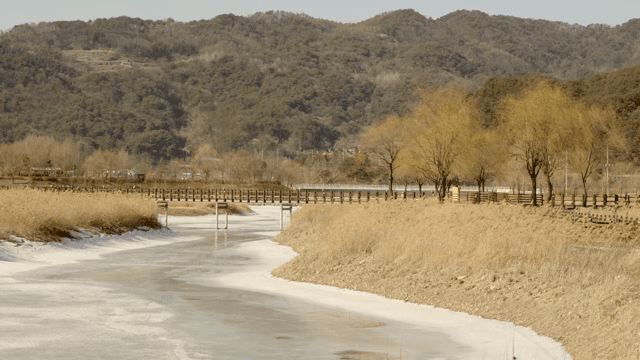 Frozen river with a wooden bridge