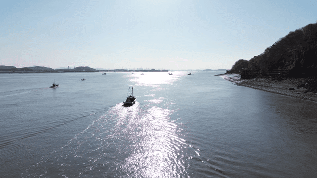 Boats sailing on a sunny river