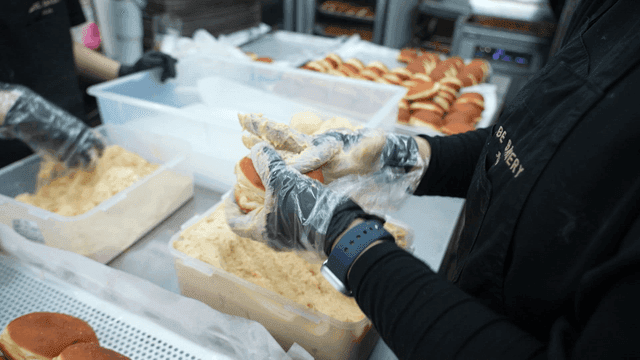 Bakery workers preparing filled breads
