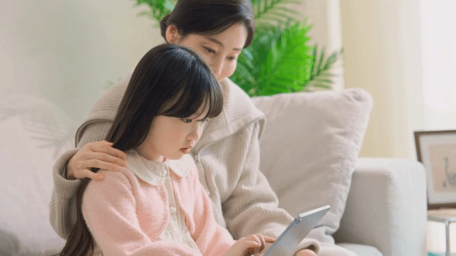Mother and daughter looking at a tablet together