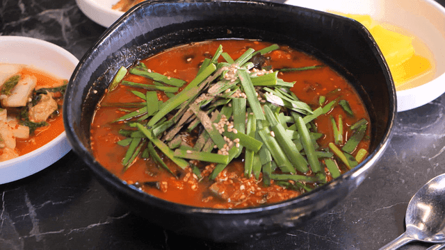 Sundubu Jjamppong and side dishes on table