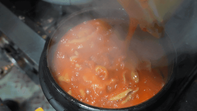 Spicy handmade dumplings poured into clay pot