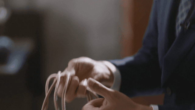 Man's hand holding rope