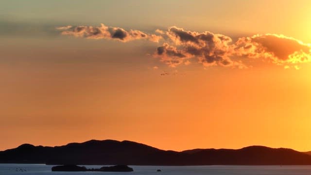 Sunset over the ocean with distant islands