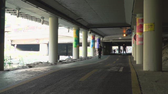 People walking and biking on the urban underground walkways