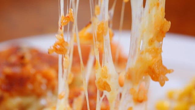 Spoonful of cheese-topped crispy rice