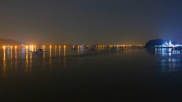 Illuminated Bridge Over Calm Waters at Night