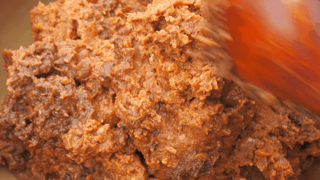 Spoon scooping out soybean paste