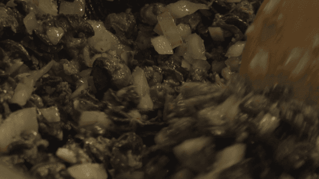 Cooking snails with onions in a pan