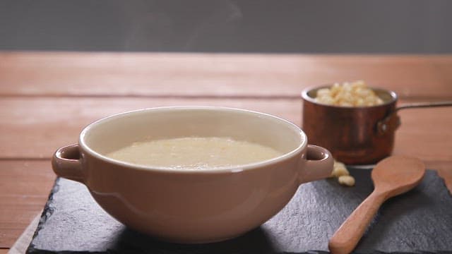 Warm Porridge in a Ceramic Bowl on Wooden Table