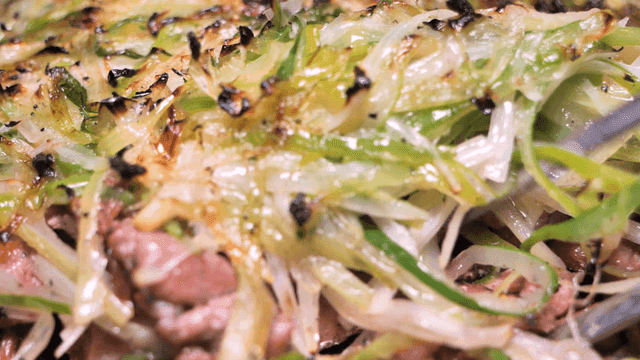 Chopsticks for picking up charcoal-grilled green onion bulgogi on foil