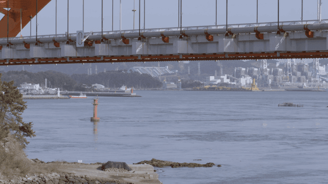 Large orange bridge over vast sea