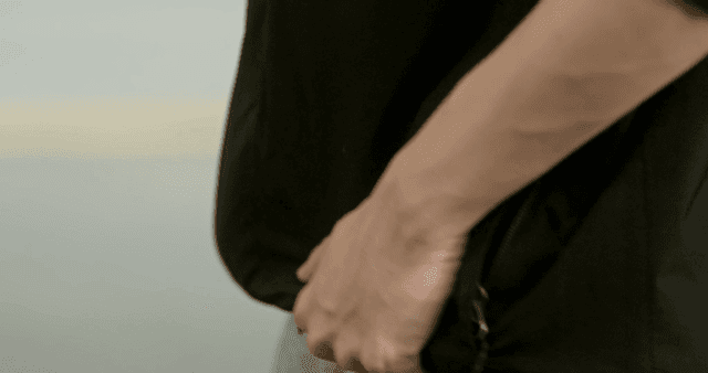 Person touching hem of jacket