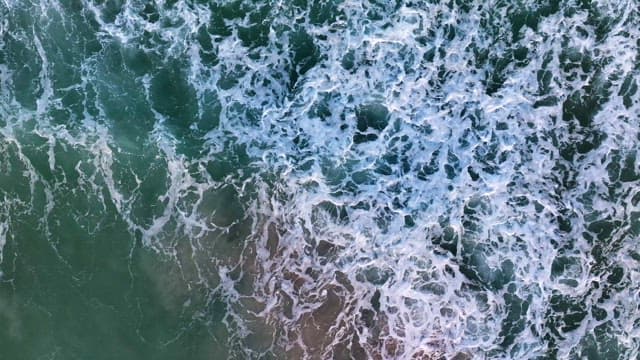 Waves crashing on a sandy beach