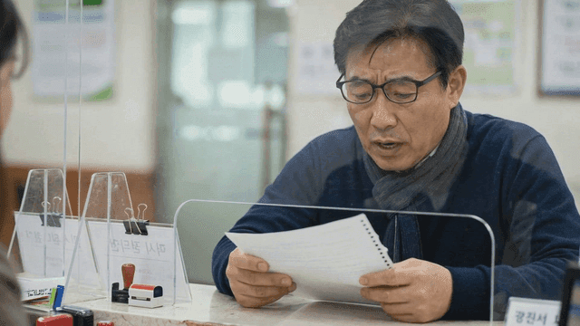 Man reviewing documents at a counter