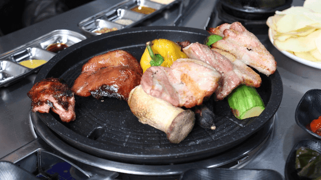 Grilled meat and vegetables on a hot plate