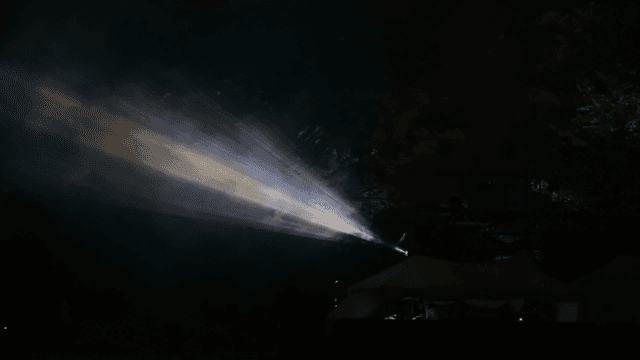 Colorful light beams in a dark outdoor setting