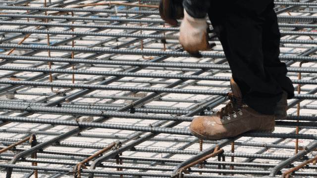 Worker securing rebar at a construction site